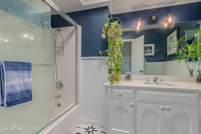 bathroom featuring tile patterned floors, vanity, and bath / shower combo with glass door