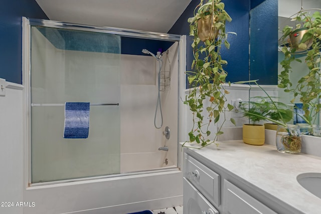 bathroom featuring vanity and bath / shower combo with glass door