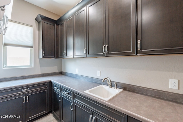 kitchen featuring dark brown cabinets and sink