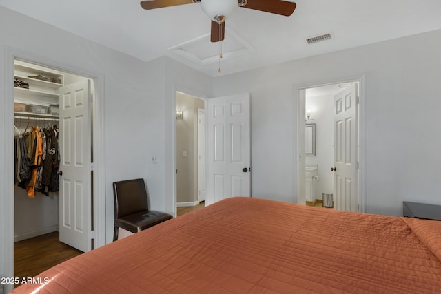 bedroom featuring ceiling fan, dark hardwood / wood-style flooring, a closet, and ensuite bath