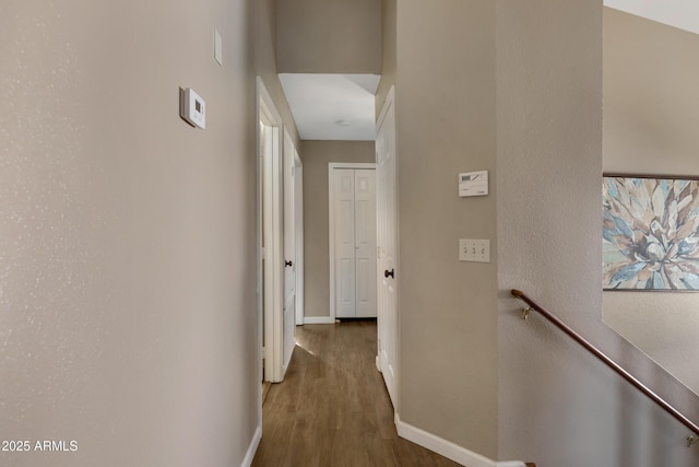 corridor with dark hardwood / wood-style flooring