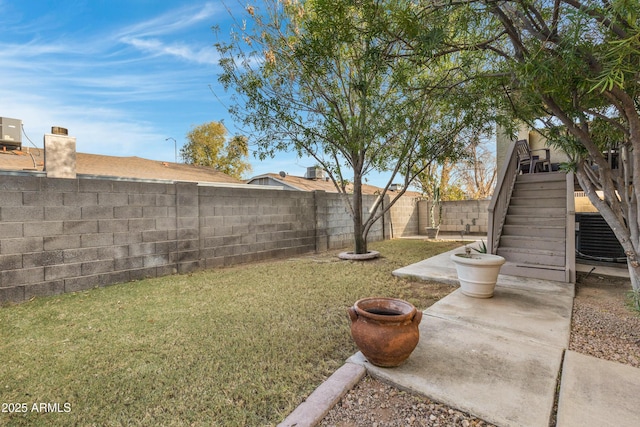 view of yard featuring central AC unit and a patio