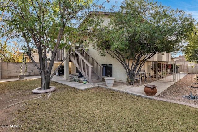 back of house featuring a yard and a patio