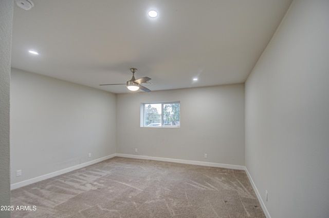 empty room featuring a ceiling fan, recessed lighting, light carpet, and baseboards