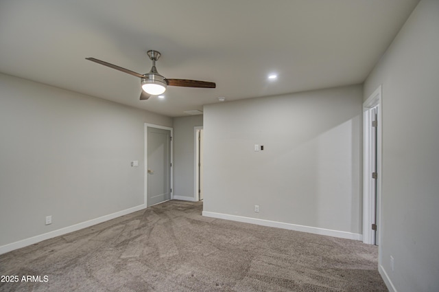 unfurnished room with a ceiling fan, baseboards, and carpet flooring