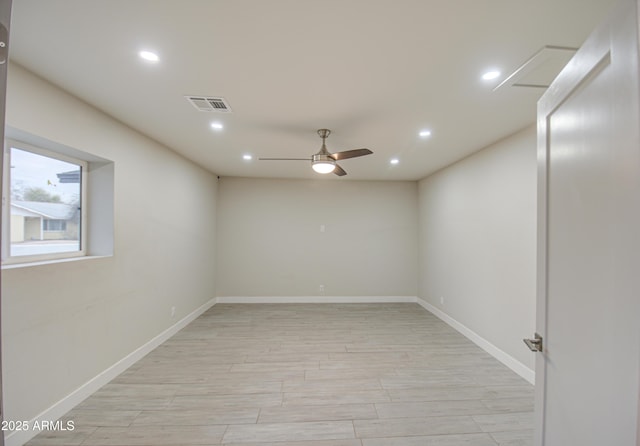 spare room featuring light wood finished floors, baseboards, visible vents, a ceiling fan, and recessed lighting