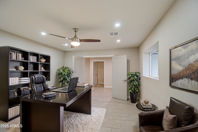 office space with a ceiling fan, recessed lighting, visible vents, and light wood finished floors