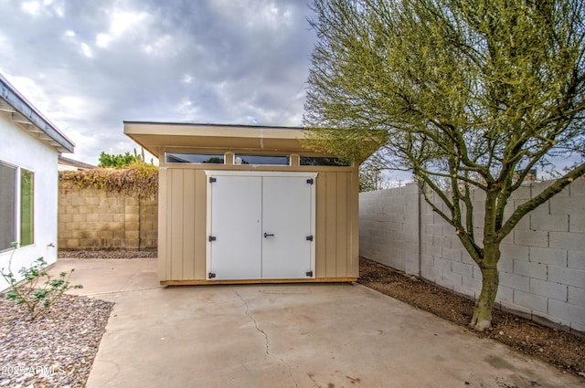 view of shed with a fenced backyard