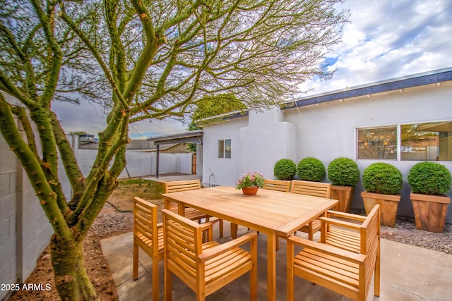 view of patio featuring fence and outdoor dining area