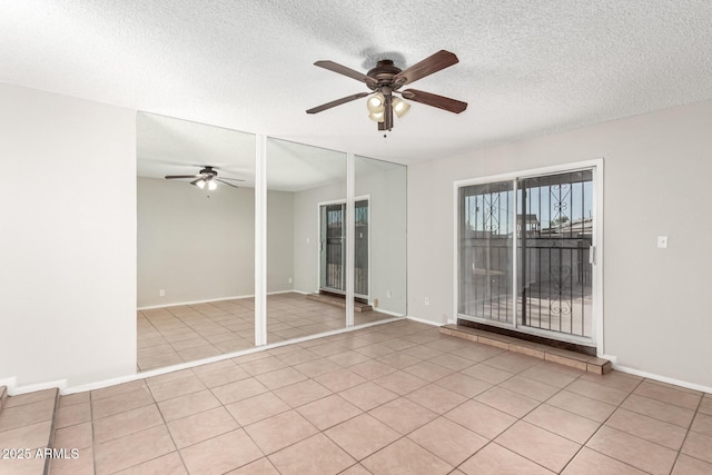 unfurnished room featuring ceiling fan, a textured ceiling, and baseboards