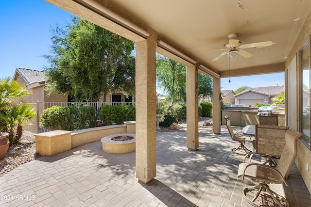 view of patio featuring an outdoor fire pit and ceiling fan