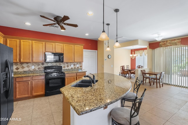 kitchen featuring decorative backsplash, ceiling fan with notable chandelier, light tile patterned floors, sink, and black appliances