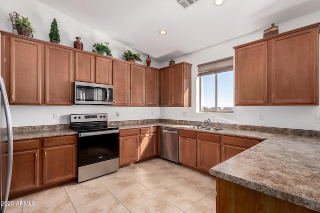 kitchen with recessed lighting, a sink, visible vents, appliances with stainless steel finishes, and brown cabinetry