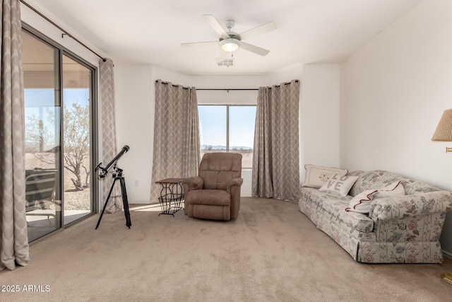 sitting room featuring ceiling fan and carpet floors