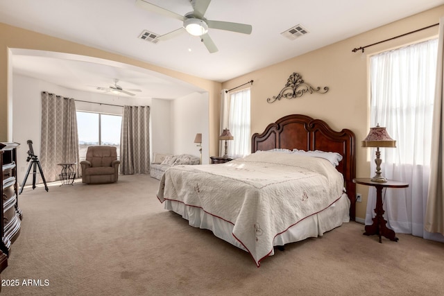 carpeted bedroom with ceiling fan and visible vents