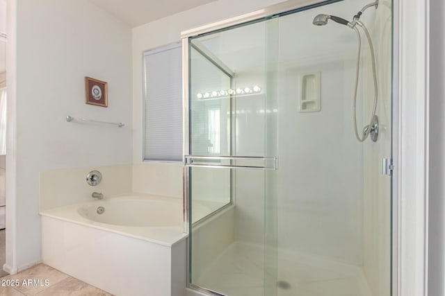 full bathroom featuring a garden tub, a shower stall, and tile patterned floors