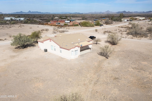 aerial view featuring a mountain view and a desert view