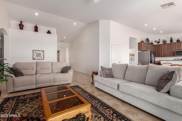 living room with arched walkways, high vaulted ceiling, light tile patterned floors, recessed lighting, and visible vents