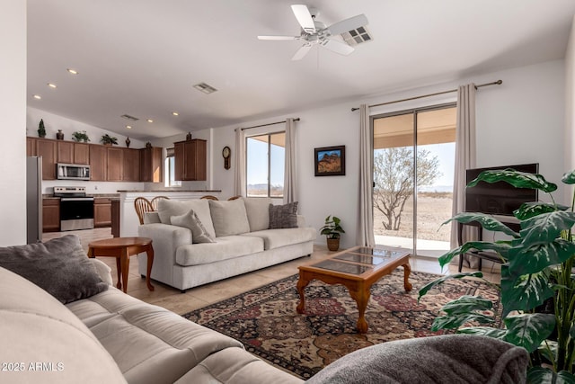 living area with light tile patterned flooring, recessed lighting, visible vents, a ceiling fan, and vaulted ceiling