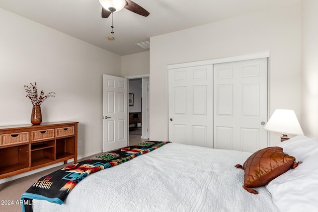 carpeted bedroom featuring ceiling fan and a closet