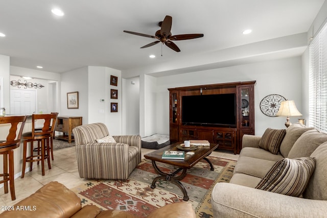 living room featuring ceiling fan and light tile patterned flooring