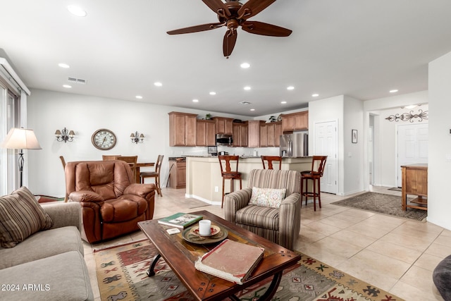 living room with ceiling fan and light tile patterned flooring