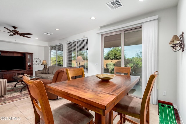 tiled dining area with a wealth of natural light and ceiling fan