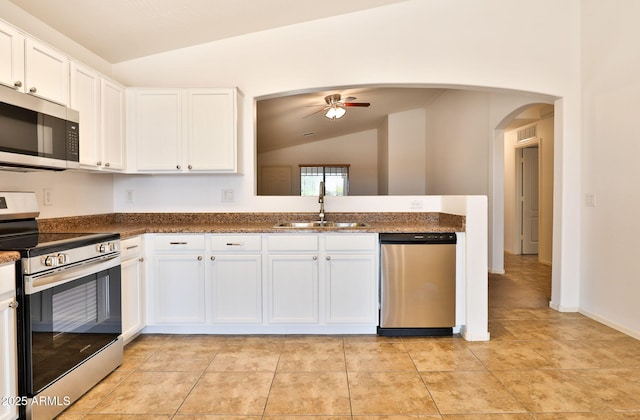 19002 N Toledo Ave, Maricopa, AZ 85138 - kitchen featuring a sink, ceiling fan, arched walkways, lofted ceiling, and appliances with stainless steel finishes