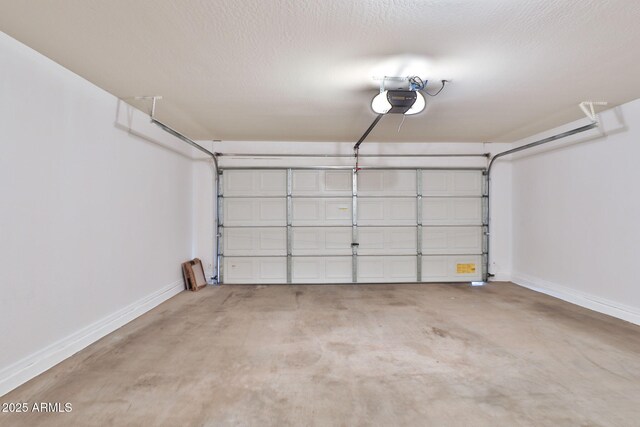 19002 N Toledo Ave, Maricopa, AZ 85138 - garage featuring baseboards and a garage door opener