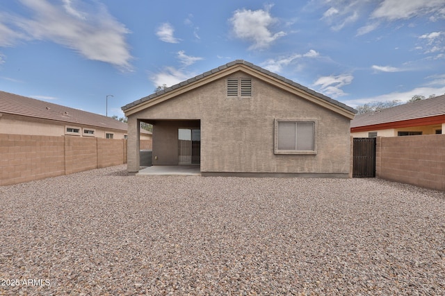 19002 N Toledo Ave, Maricopa, AZ 85138 - rear view of property with a fenced backyard, a patio area, a tiled roof, and stucco siding