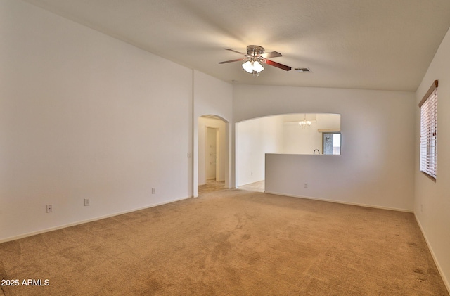 19002 N Toledo Ave, Maricopa, AZ 85138 - unfurnished room with light colored carpet, arched walkways, visible vents, and ceiling fan with notable chandelier