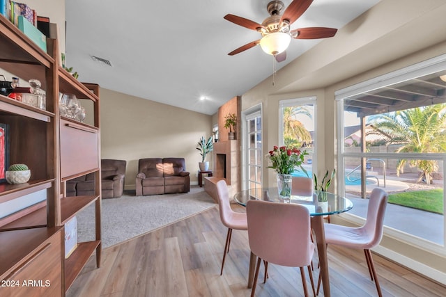 dining space featuring light hardwood / wood-style floors, lofted ceiling, and ceiling fan