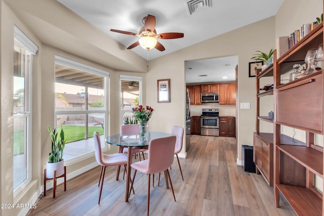 dining area featuring lofted ceiling, ceiling fan, and light hardwood / wood-style flooring