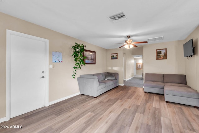 unfurnished living room featuring ceiling fan and light hardwood / wood-style floors