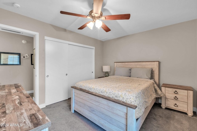 bedroom featuring ceiling fan, dark colored carpet, and a closet