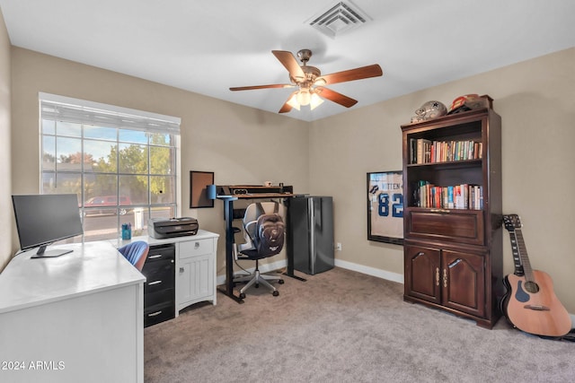 carpeted office featuring ceiling fan