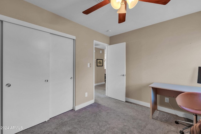 carpeted office space featuring ceiling fan