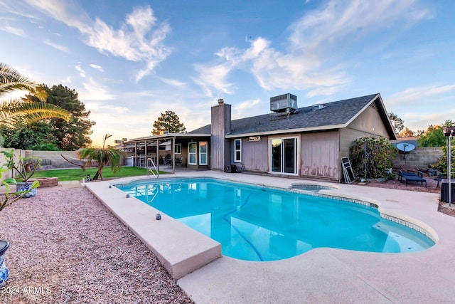 view of swimming pool with a patio and cooling unit