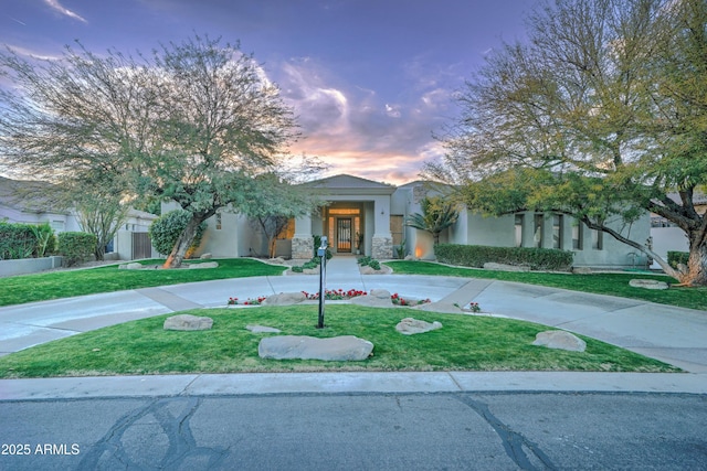 obstructed view of property with a lawn