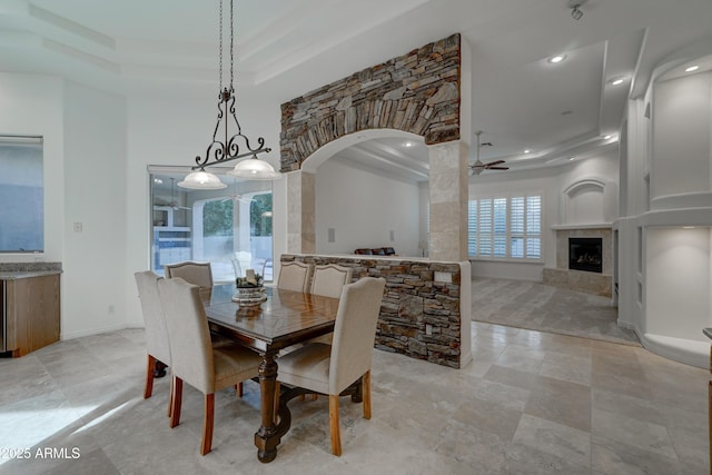 dining room with a raised ceiling and ceiling fan