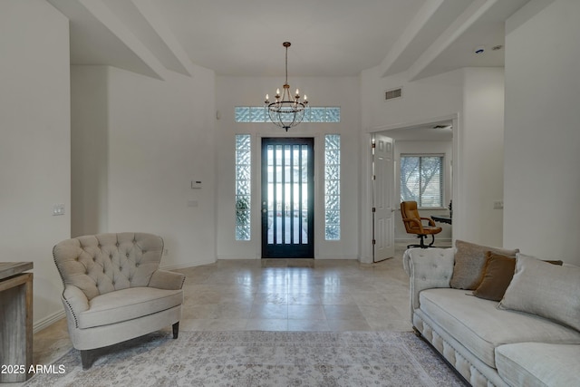 tiled foyer with an inviting chandelier