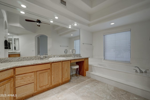 bathroom featuring ceiling fan, vanity, and a bathtub