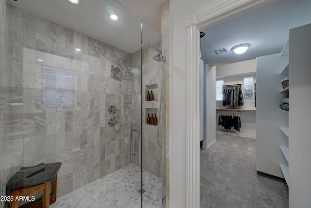 bathroom featuring a shower with shower door