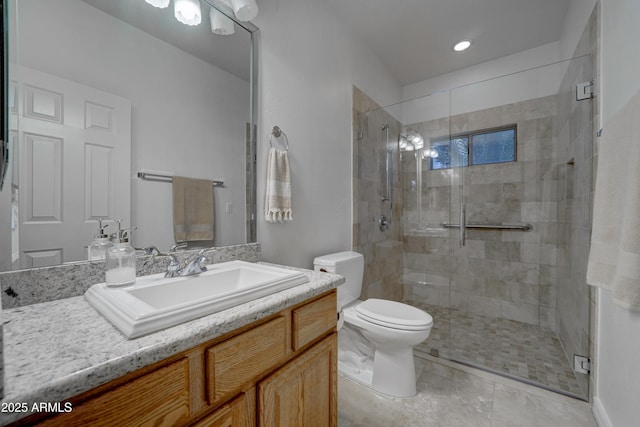 bathroom with a shower with door, vanity, and toilet