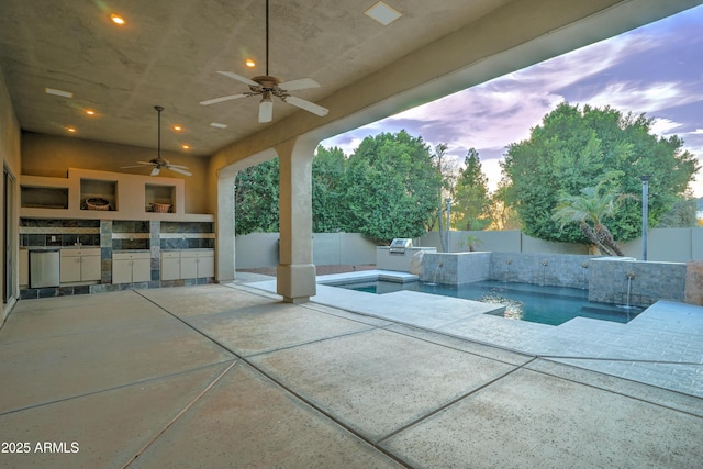 pool at dusk featuring ceiling fan, an outdoor kitchen, grilling area, and a patio area