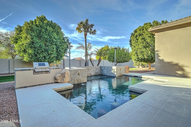 view of pool with area for grilling, a patio, and pool water feature