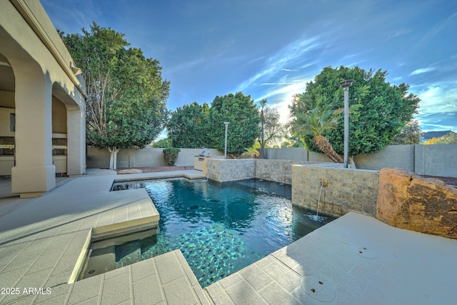 view of swimming pool featuring a patio area and pool water feature