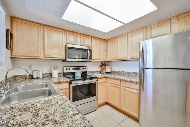 5757 W Eugie Ave Unit 2068, Glendale, AZ 85304 - kitchen featuring stainless steel appliances, light brown cabinetry, a sink, and light tile patterned floors