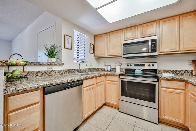 5757 W Eugie Ave Unit 2068, Glendale, AZ 85304 - kitchen featuring stainless steel appliances, light brown cabinets, a sink, light tile patterned flooring, and light stone counters