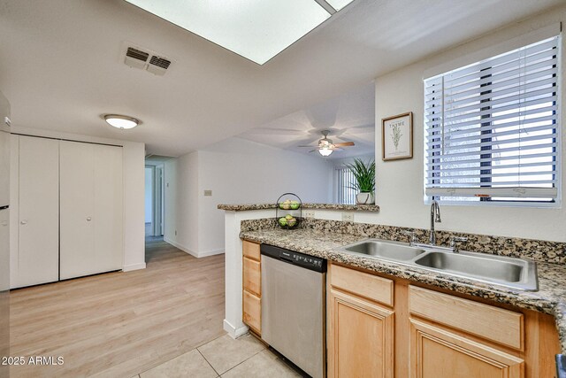 5757 W Eugie Ave Unit 2068, Glendale, AZ 85304 - kitchen with stainless steel dishwasher, a sink, light brown cabinetry, ceiling fan, and light wood-type flooring